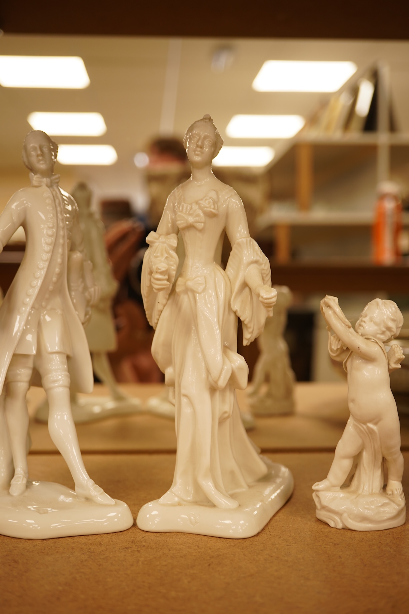 Two Nymphenberg white glazed figures, after Bustelli and two similar cherubs (4) figure 19 cm high
